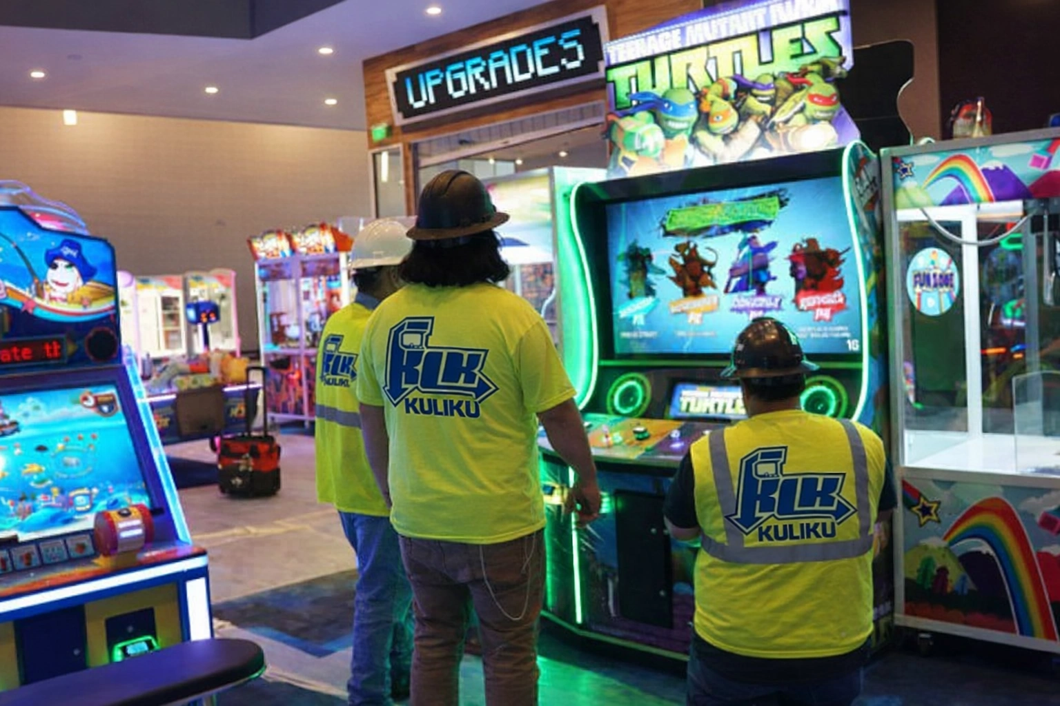 Kuliku technicians installing and testing arcade machines at an entertainment venue